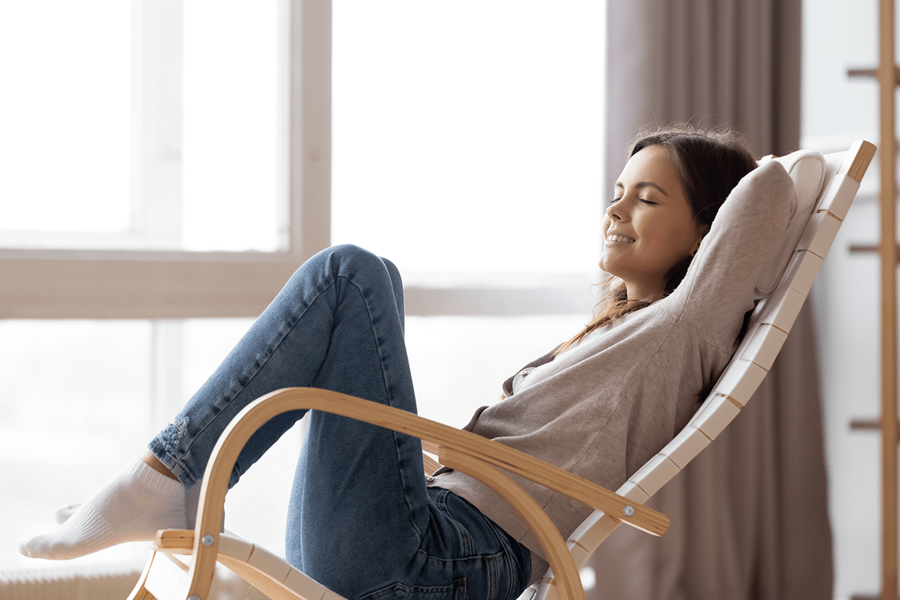 woman sitting in chair with eyes closed relaxing